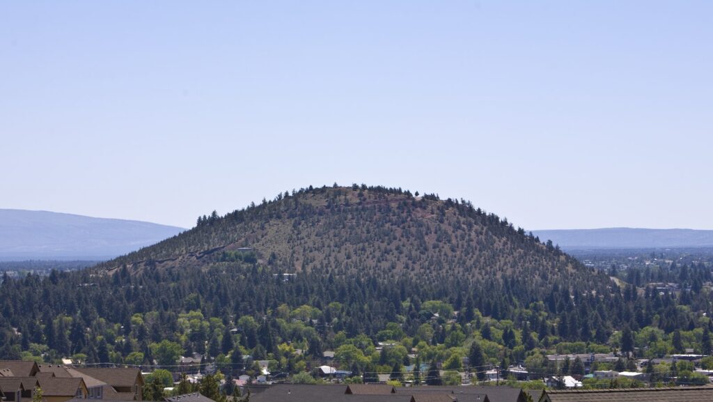 Pilot Butte cinder cone rising above east Bend neighborhoods, Oregon